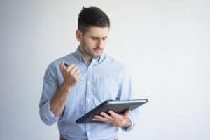 portrait of serious young businessman with folder and pen