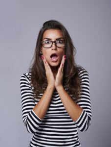 shocked girl with her head in hands