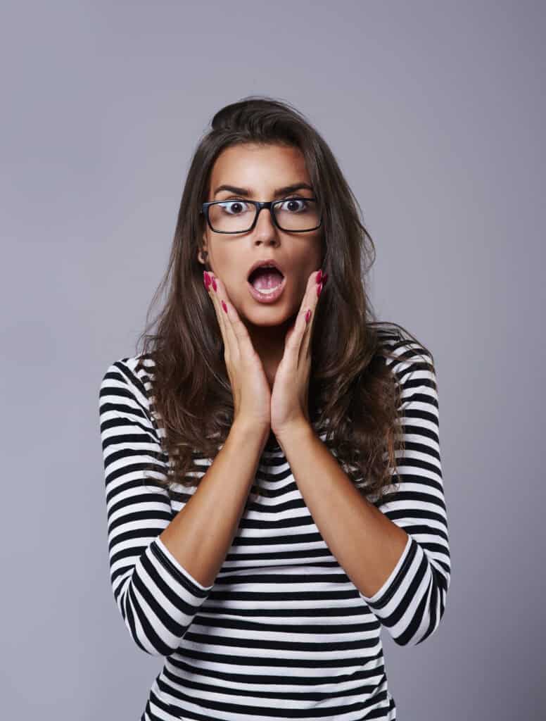 shocked girl with her head in hands
