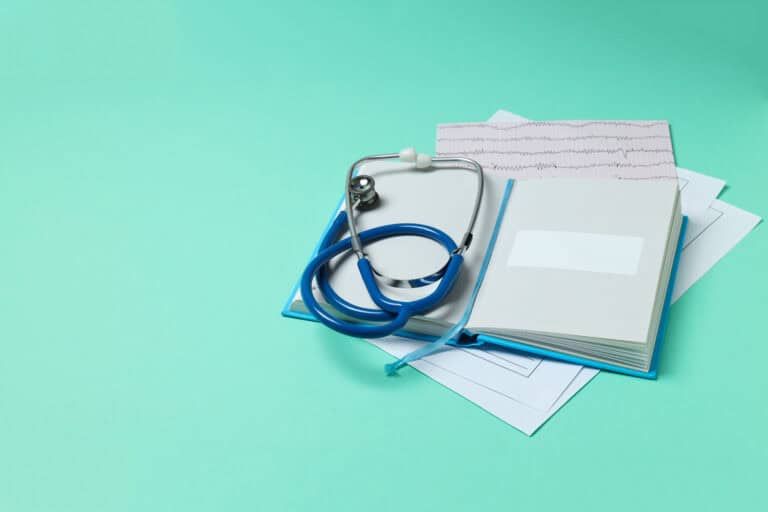 medical literature book and medical accessories on mint backgr