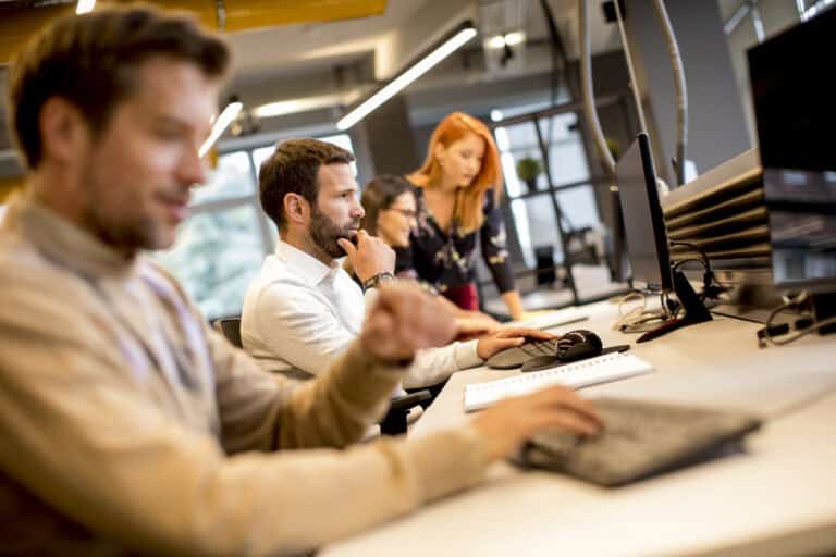 young professional businessman uses a computer for work in the o